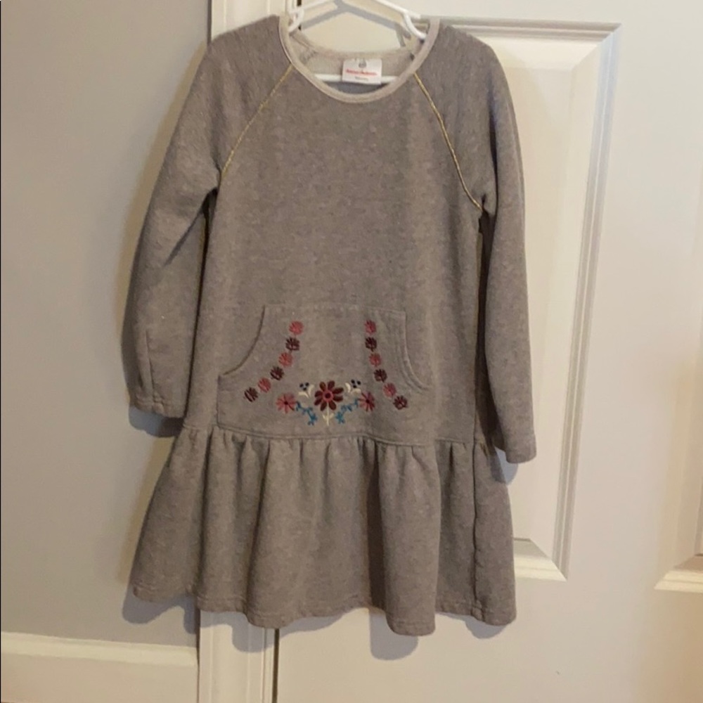 A grey dress with flowers on the pocket